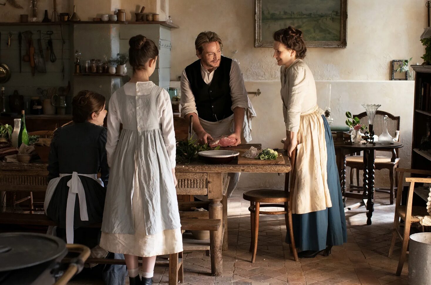A man and three women in the kitchen